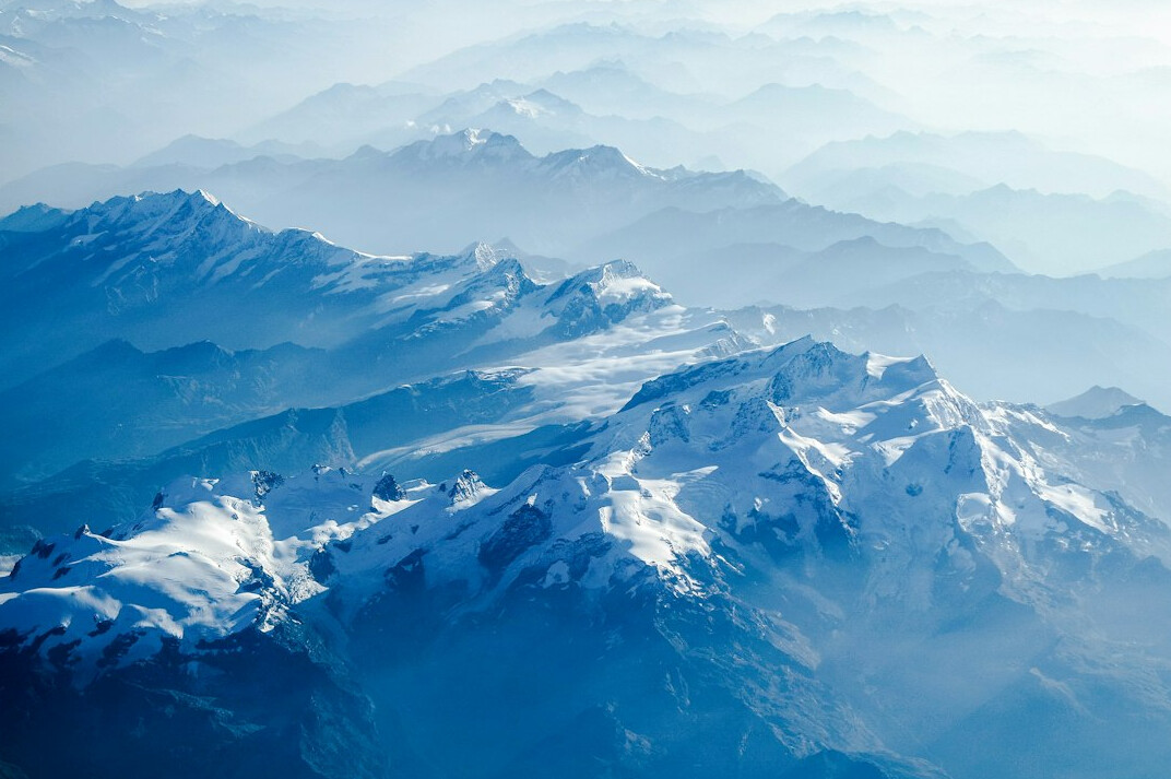 Snow-capped mountain peaks under a blue sky