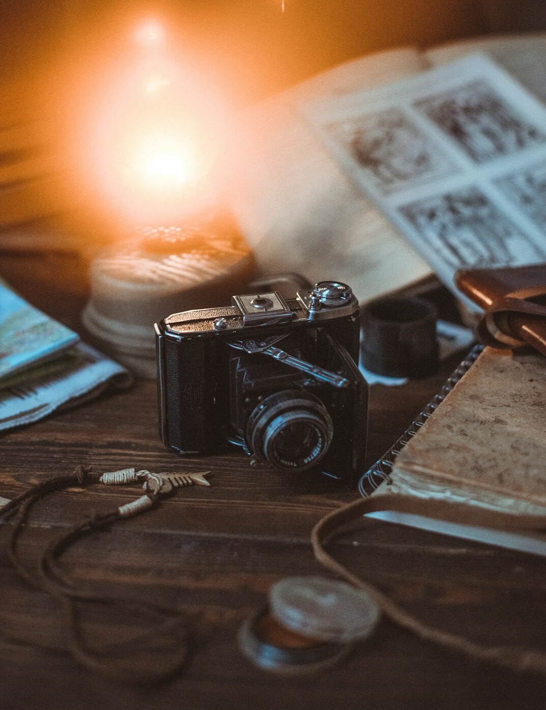 Travel map with camera and notebook on a table